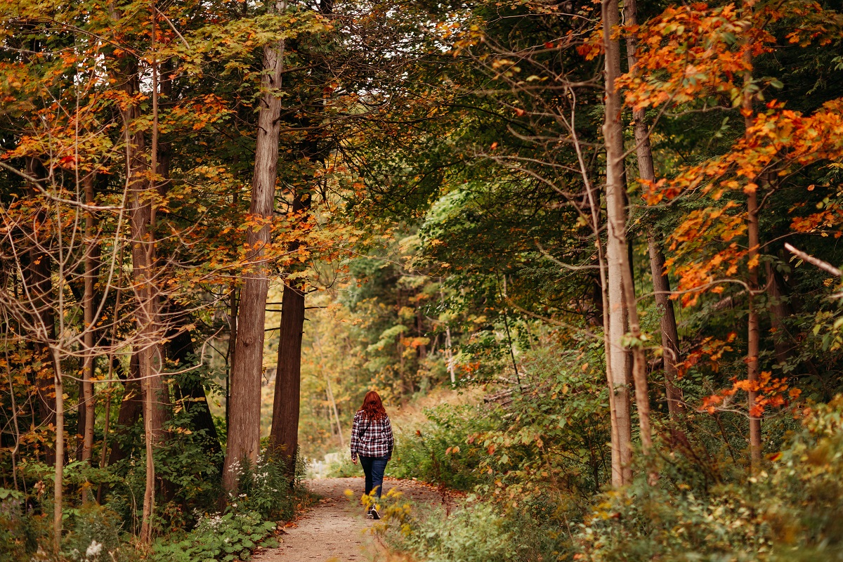 Shelly walking in fall colours on the carrol trail in Tillsonburg