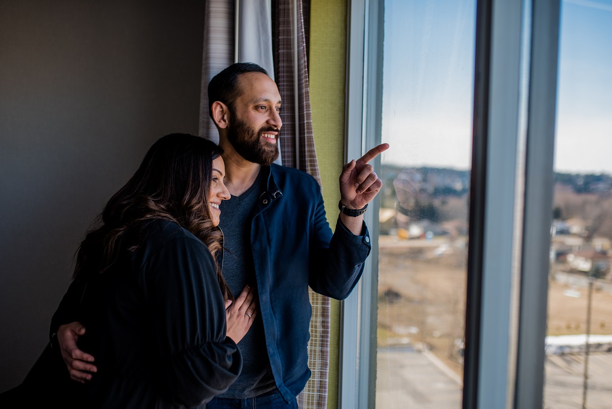 couple in their room looking out the window at the holiday inn express